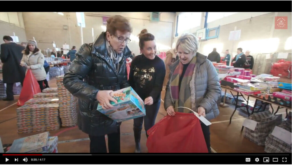 Women collecting toys in a sack