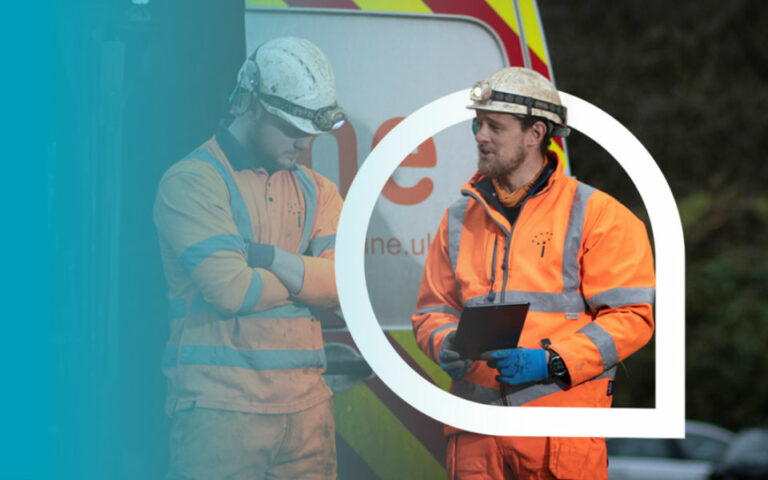 Workmen in hi-vis searching the internat on a tablet