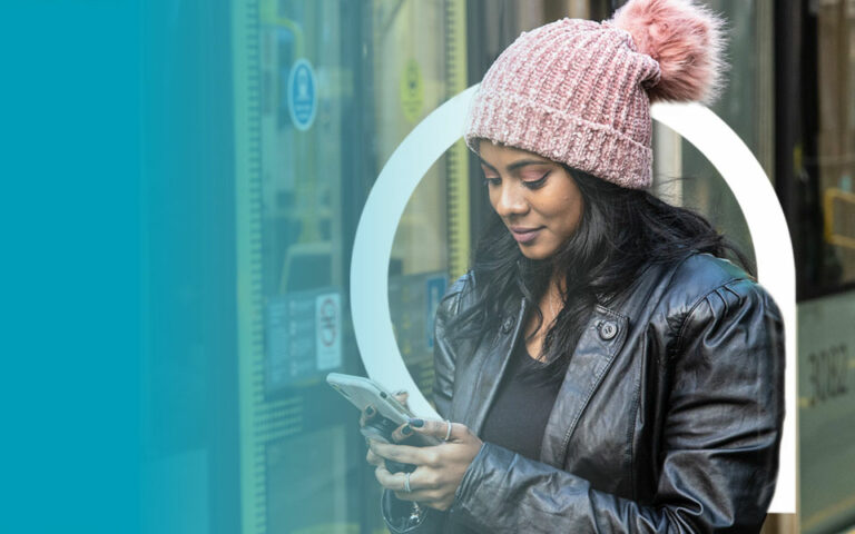 Female searching Google on Metrolink tram platform