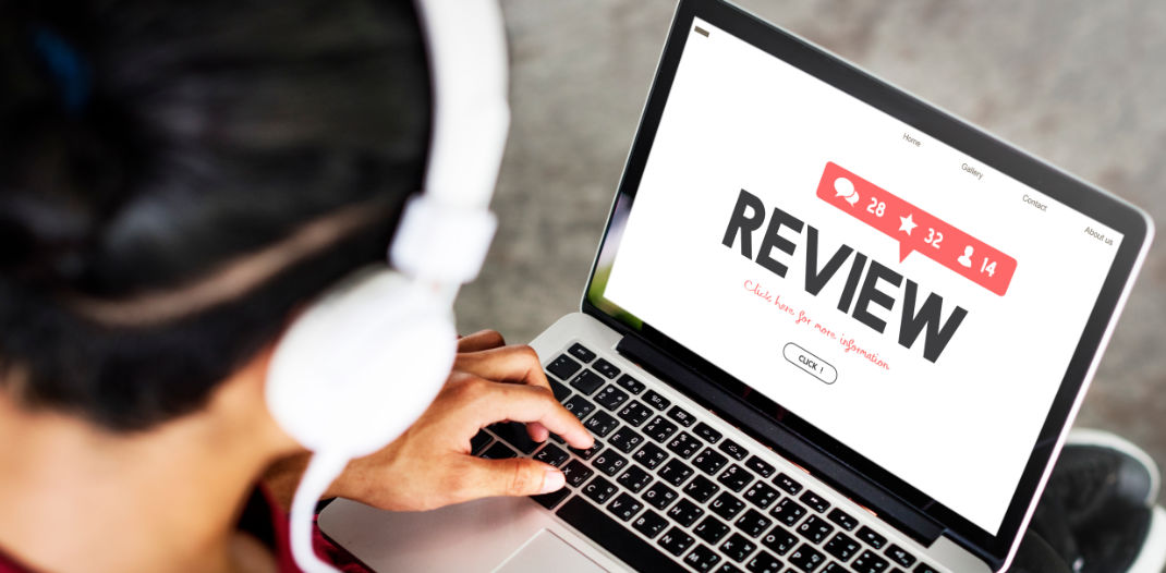 Man on laptop leaving online review