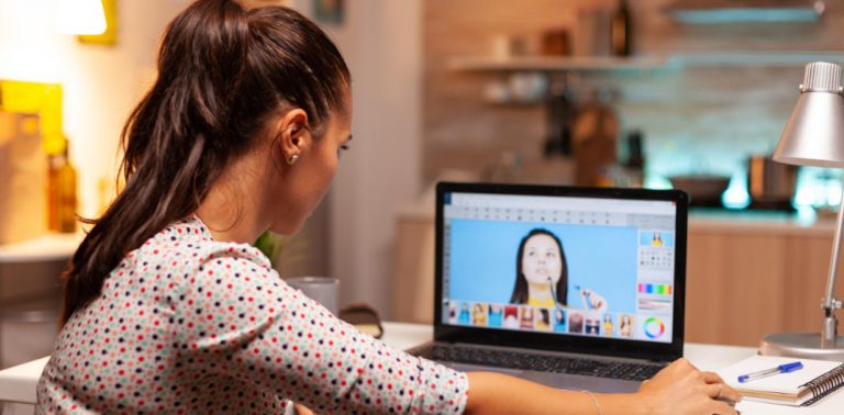 Woman editing image on her laptop