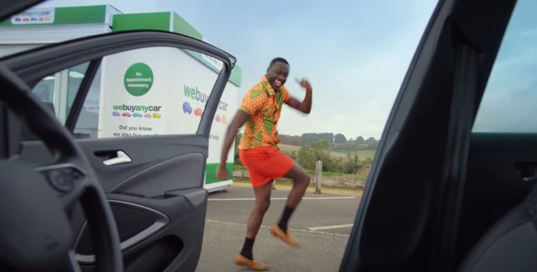 We buy any car advert 2023 screen shot with Mufasa dancing outside car
