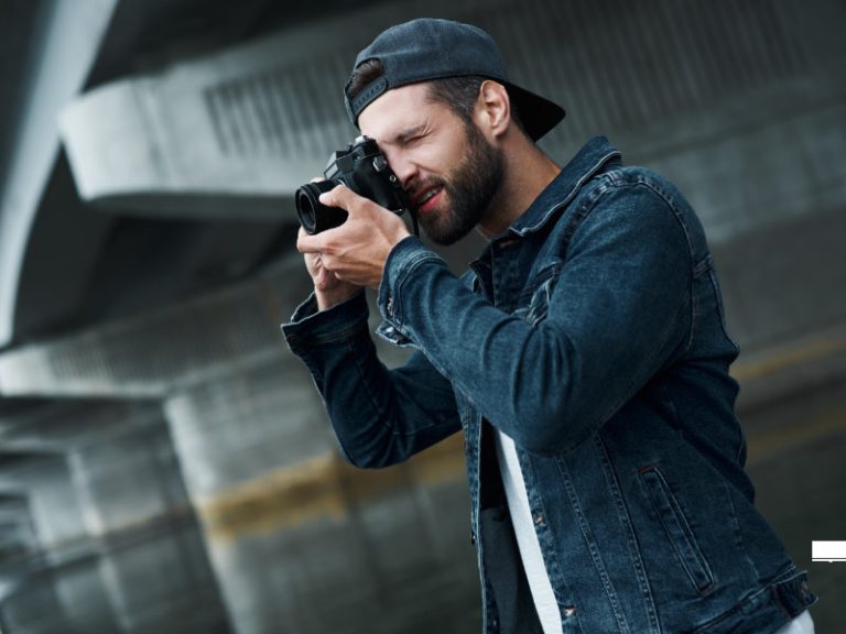 Man taking a photograph so that he can upload it to his website with relevant meta data