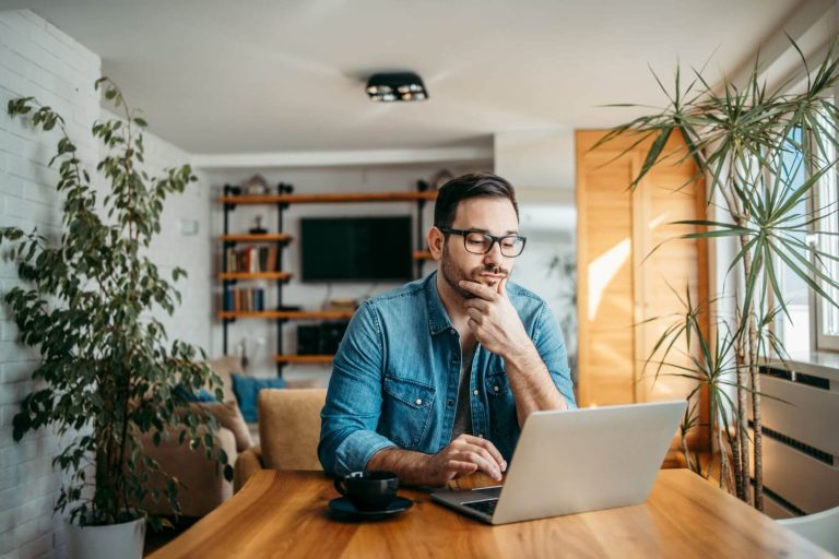 Man thinking at laptop