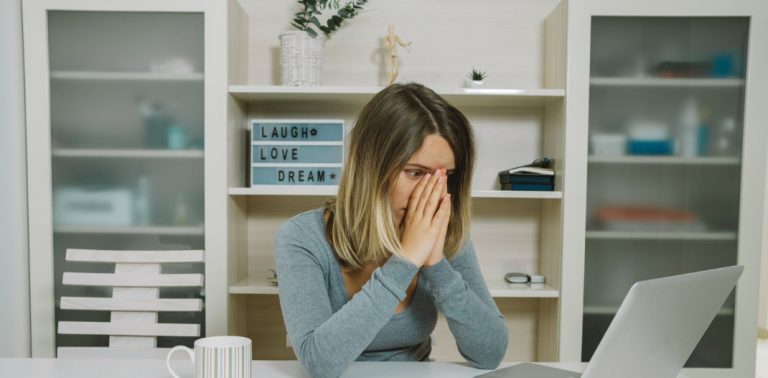 Woman looking concerned at laptop