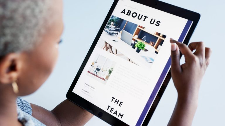 Woman viewing a website with h1 title 'About Us'